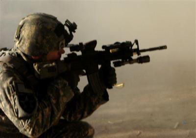 Sgt. 1st Class James Tembrock, platoon sergeant of 1st Platoon, fires his M-4 rifle during a firefight with al-Qaida in Iraq operatives near an insurgent safehouse south of Hussein Hamadi village, Diyala province, Iraq, Oct. 29, during Operation Ultra Magnus. Coalition forces killed four AQI members who were using the home as a base of operations to conduct terrorist activities in southern Diyala province.