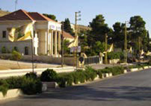 The Hezbollah flag flies in a street.