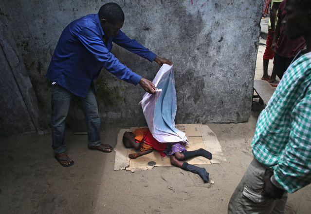 A young ebola victim is covered with a sheet in Monrovia, Liberia