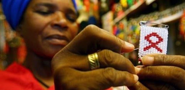 Swazi woman holding HIV awareness badge