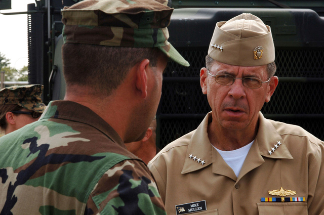 Chief of Naval Operations (CNO) Adm. Mike Mullen listens to Commanding Officer of Riverine Squadron One, Cmdr. William J. Guarini Jr., explain the features of the combat vest during a visit of Riverine Group One (RIVRON-1) and Riverine Squadron One on board Naval Amphibious Base Little Creek.