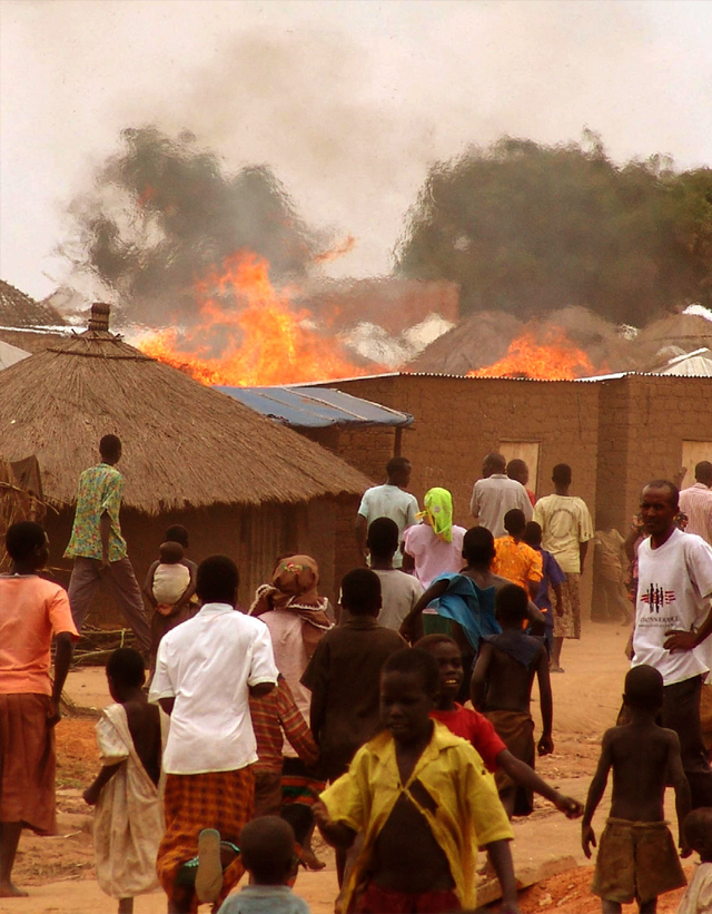 A fire sweeps through a refugee camp for those displaced by the conflict between the Lord’s Resistance Army and the Ugandan Government