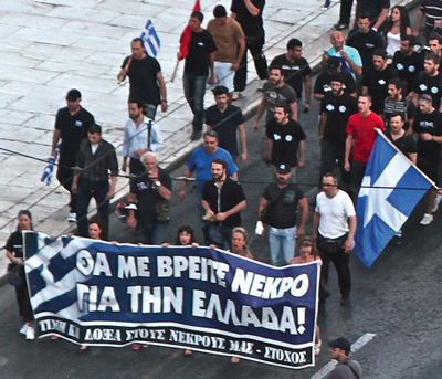 Golden Dawn demonstration in Athens June 27, 2012. The sign reads ‘Watch me die for Greece'