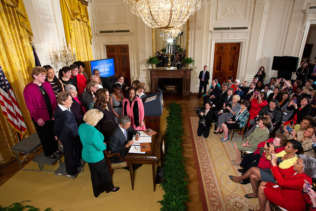 President Obama signs executive actions to strengthen enforcement of equal pay laws for women, at an event marking Equal Pay Day in the East Room of the White House, April 8, 2014.